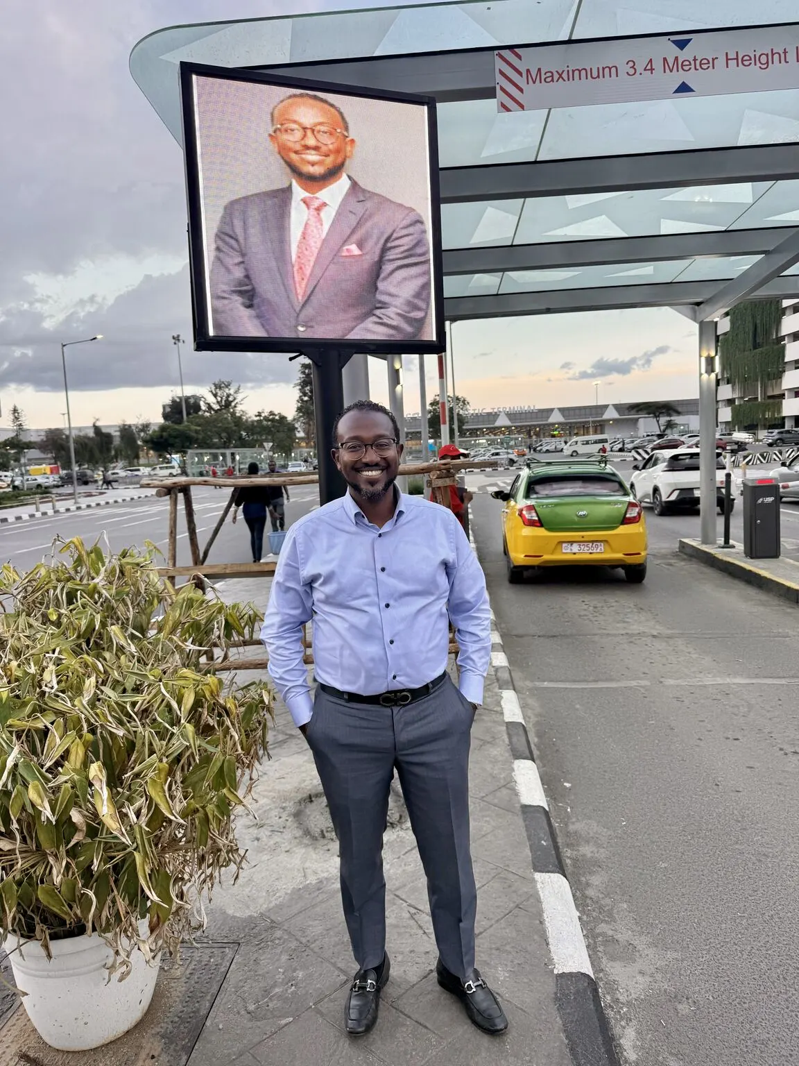 Ben Tesfaye standing in front of an operating parking gate at Addis Ababa Bole International Airport